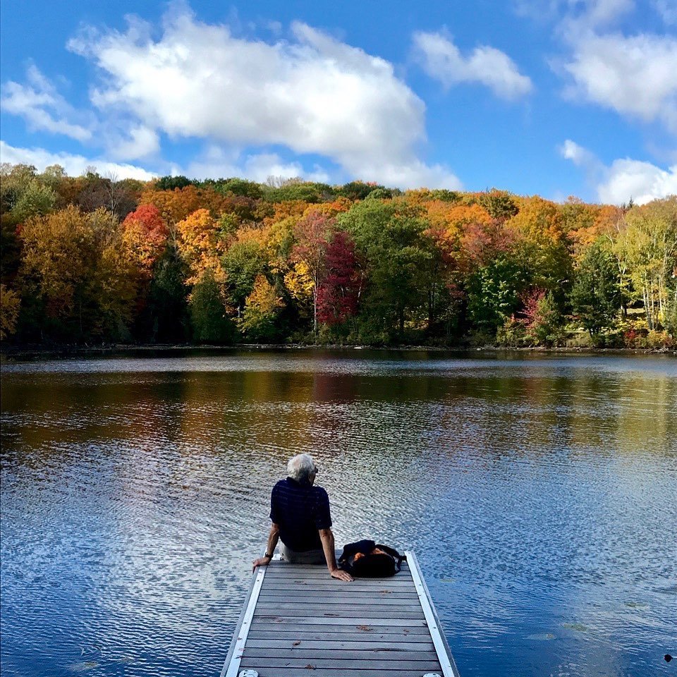 person sitting on a dock in the Haliburton Highlands