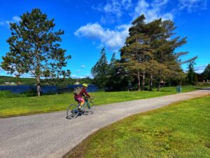 Cyclist riding along path to Head lake Park