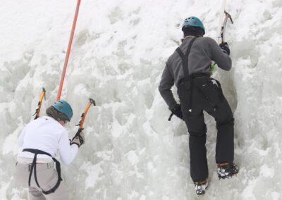 two people climbing ice