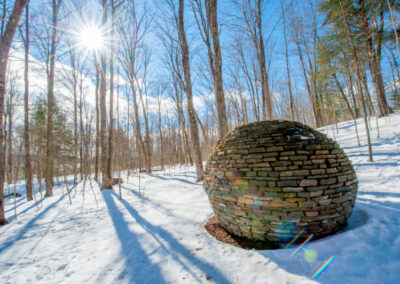 stone globe in the snowy forest