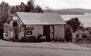 old photo of Buttermilk Falls original general store and gas pumps