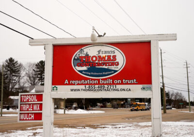 Thomas Contracting business sign next to the Highway